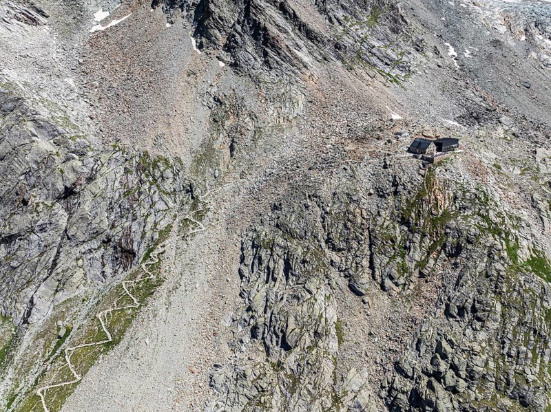 Mountain hut Cabane de Moiry, serpentines of hiking trail, aerial view, Valais, Switzerland, Europe