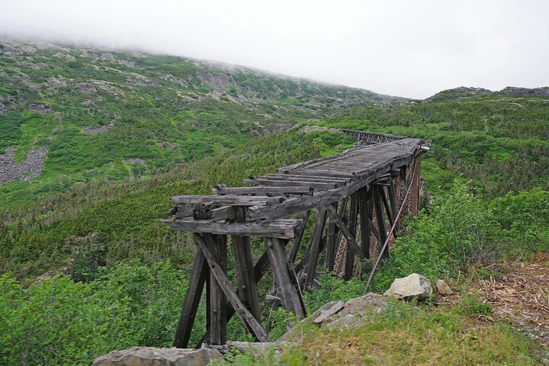 Remains of an old wooden railway bridge, wilderness, mountain landscape, White Pass Railway, Skagway, Alaska, USA, North America