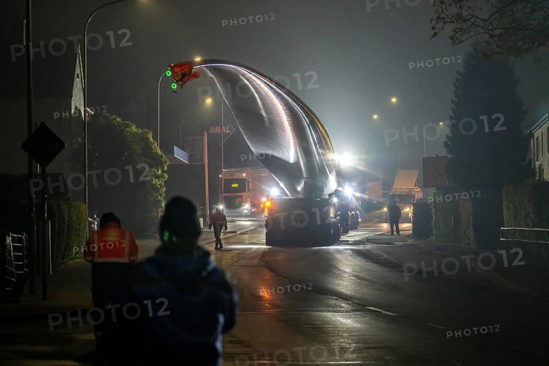 Transport of a 68 metre long, 22 tonne blade of a wind turbine, here in Breckerfeld, with a self-propelled Blade-Lifter vehicle, over a 40 km long route, over 2 nights, in the Bergisches Land, through towns, villages, over country roads, narrow through roads, to the construction site of the wind turbine near Hagen, North Rhine-Westphalia, Germany, Europe