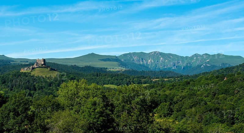 View of the medieval castle of Murol and the Sancy massif in the Auvergne Volcanoes Regional Natural Park, Puy de Dome, France, Europe
