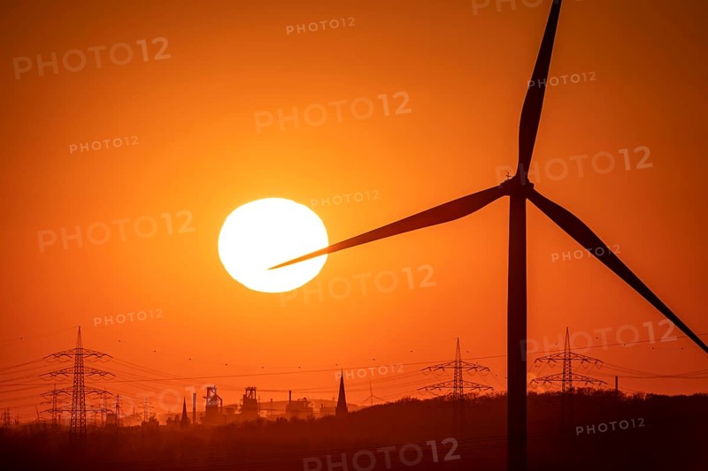 Wind turbine of the Emschergenossenschaft, view to the west, in Essen, sunset, behind the blast furnaces 8 and 9 of Thyssenkrupp Steel, in Duisburg, North Rhine-Westphalia, Germany, Europe