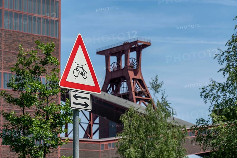 Cycling in the Ruhr area, at the Zollverein Coal Mine Industrial Complex World Heritage Site, double trestle winding tower shaft XII, Essen, North Rhine-Westphalia, Germany, Europe