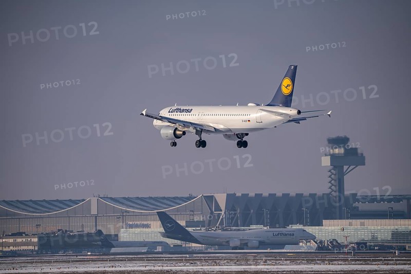 Lufthansa Airbus A320-200 approaching Frankfurt FRA airport, air traffic control tower, Fraport, in winter, Hesse, Germany, Europe