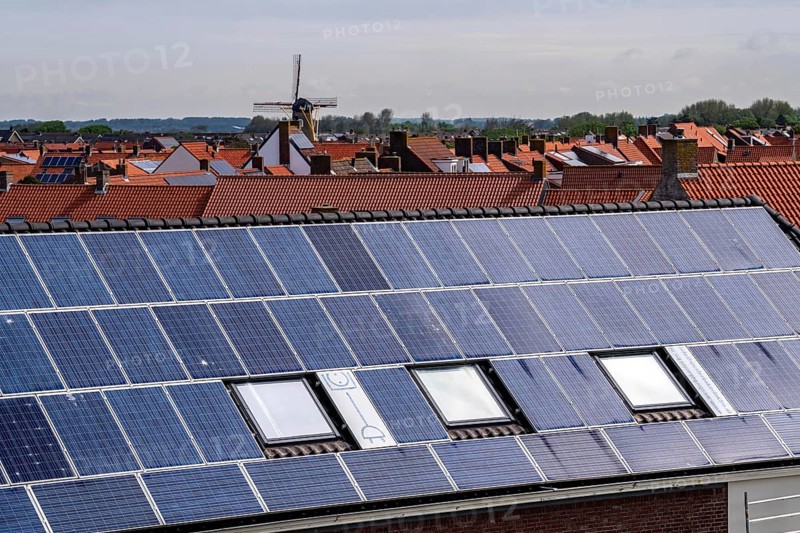 Solar modules on roofs, on the roof of a building on the dyke, North Sea coast, in Zeeland, Westkapelle, Netherlands