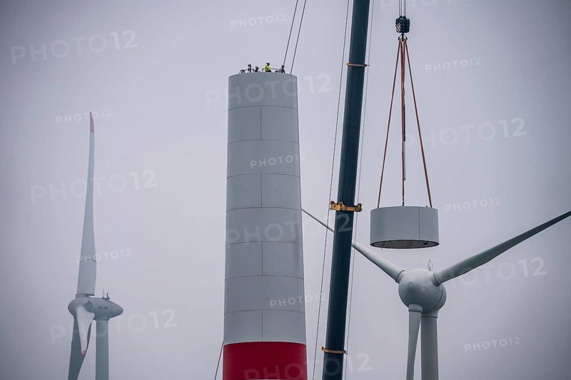 Construction of the tower of a wind power plant in a wind farm near Issum, 9 older wind turbines from the manufacturer Enercon (model series E-58) at the rear right, which have been in operation for over two decades, will be replaced by a total of four Enercon E-160 turbines, under construction, with a total output of 22 megawatts, Lower Rhine, North Rhine-Westphalia, Germany, Europe