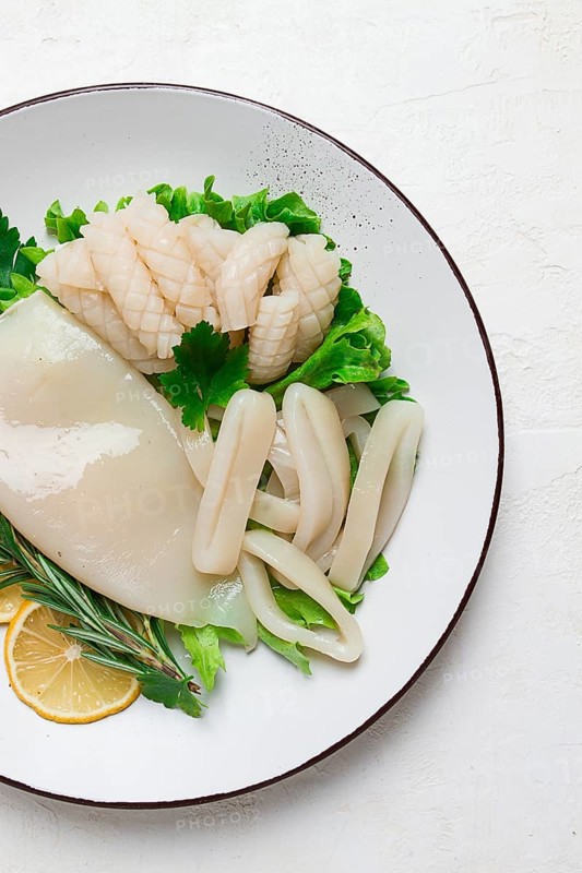 Fresh squid, raw, carcass, cut into rings, top view, no people