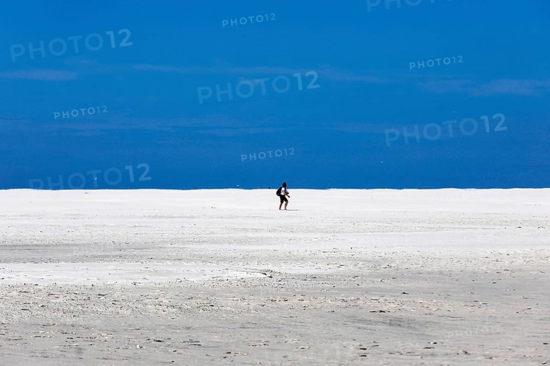 DEU, 18.06.2020, A holidaymaker walks through the knee sand on the beach of the island of Amrum, Wittdün