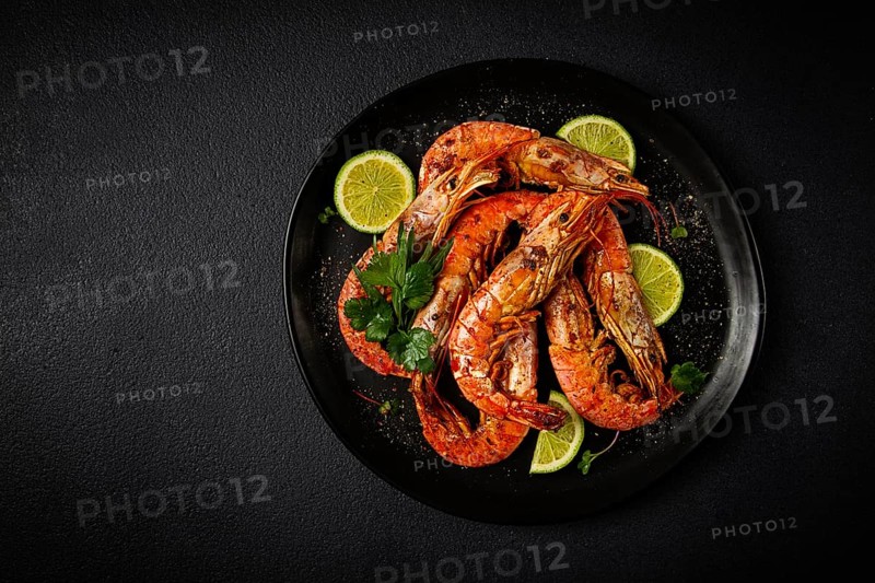 Langoustines, Australian, freshly frozen on ice, top view, lime and greens
