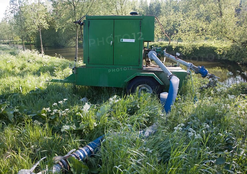 Irrigation water pump machinery on the River Stour at Bures, Essex, England, United Kingdom, Europe