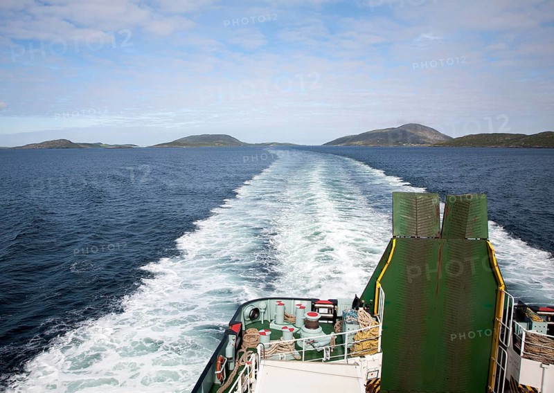 Ship's wake in sea of Caledonian MacBrayne ferry ship leaving Barra, Outer Hebrides, Scotland, UK