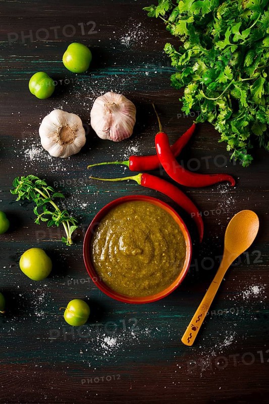 Tkemali sauce, traditional Georgian cuisine, green cherry plum, with ingredients for sauce, cilantro, mint, hot pepper, garlic, on a wooden table, close-up, rustic, food background, no people, selective focus, sauce, green sauce, tkemali, georgian cuisine, homemade