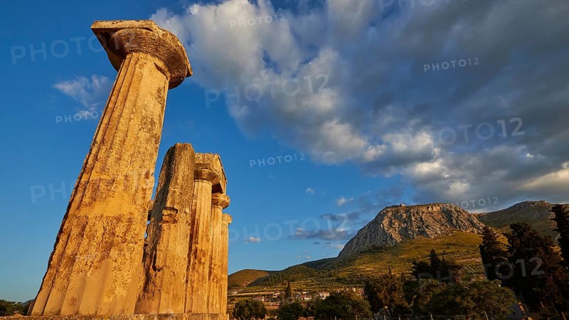 Archaic Temple of Apollo, Doric Columns, Doric columns of ancient ruins under a dramatic sunset sky, Archaeological site, Archea Korinthos, Corinth, Peloponnese, Greece, Europe