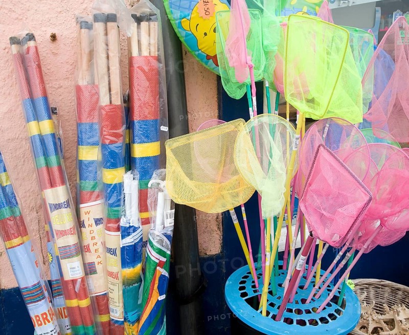 Windbreaks and children's fishing nets on sale at the seaside town of Cromer, north Norfolk coast, England, United Kingdom, Europe