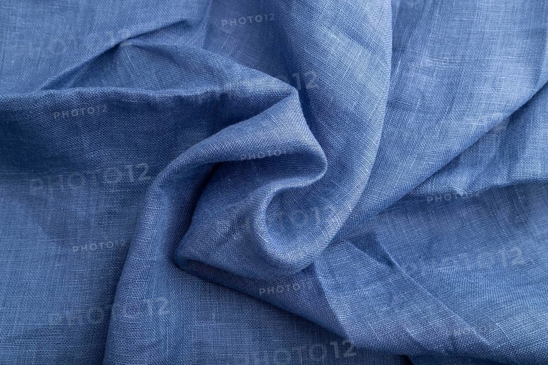 Fragment of blue linen tissue. Top view, natural textile background and texture. wave concept, abstract, spiral