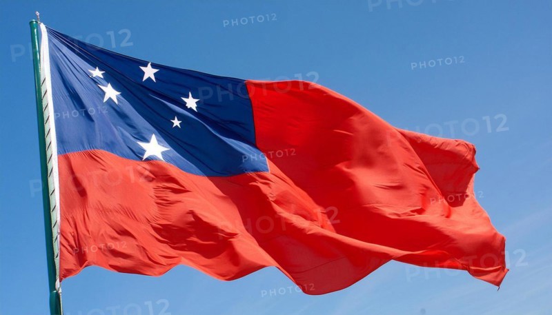 The flag of Samoa, fluttering in the wind, isolated against a blue sky