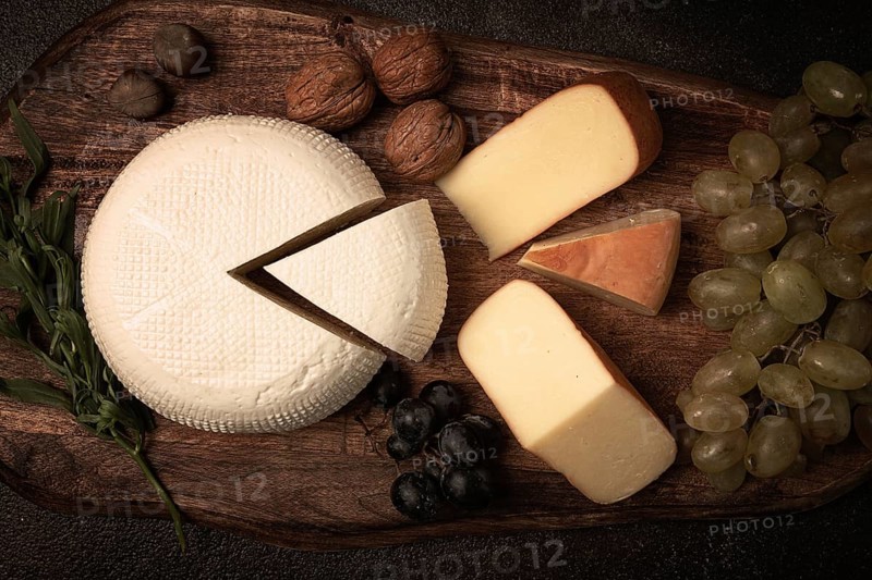Georgian cheese, Imeretian and smoked suluguni, grapes, nuts, on a cutting board, Georgian cuisine, no people
