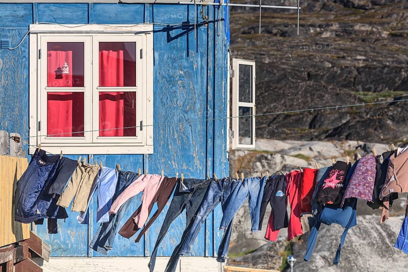 Laundry drying in the wind in front of the house, Inuit settlement, Ittoqqortoormiit, East Greenland, Greenland, North America