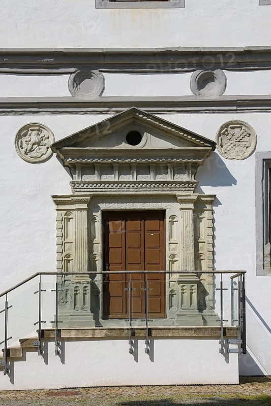 Door in the inner courtyard, castle courtyard, wooden door, entrance, coat of arms medallions, stucco, façade design, indicated columns, Meßkirch Castle, castle of the Counts of Zimmern, Zimmern Castle, regular four-wing castle complex, Renaissance building, architecture, historical building, Meßkirch, Sigmaringen district, Baden-Württemberg. Germany