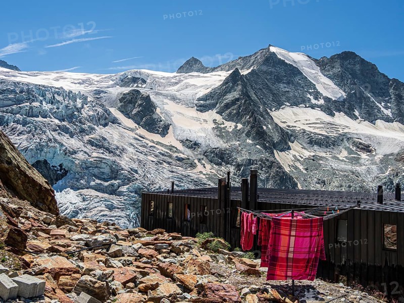 Colored bed linen dries in the sun, mountain hut Cabane de Moiry, located close to the retreating Moiry glacier, Valais, Switzerland, Europe
