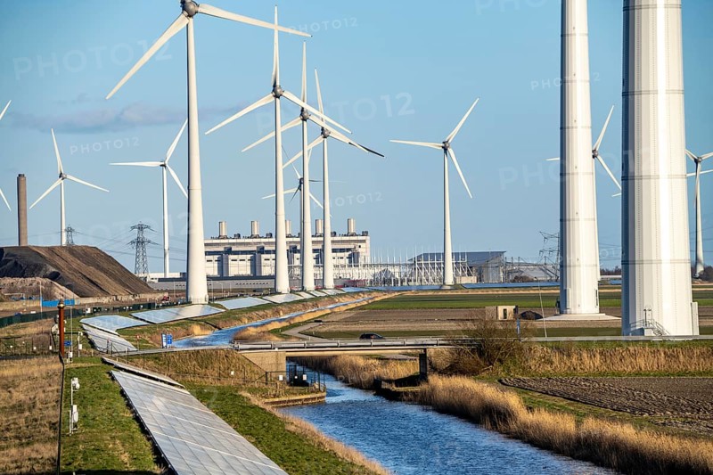 Solar park on the Slaperdijk dyke near the Eemshaven, test project, 17, 000 solar modules were installed over a good 5 km, the Netherlands has over 22, 000 km of dyke line, here it is being tested whether such an installation is successful and can be expanded, wind farm, behind the Eemscentrale gas and steam power station, Groningen, Netherlands