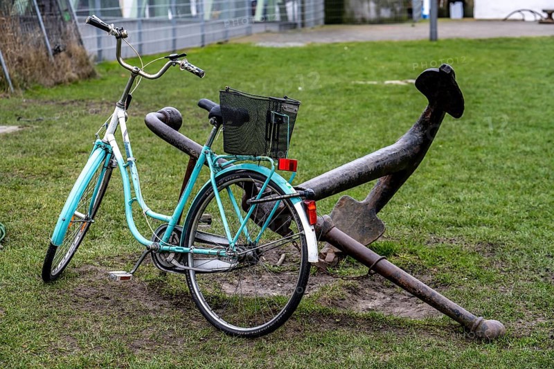 Bicycle, ladies' bicycle, well secured with a bicycle lock to an iron ship's anchor, in Bremerhaven, Bremen, Germany, Europe