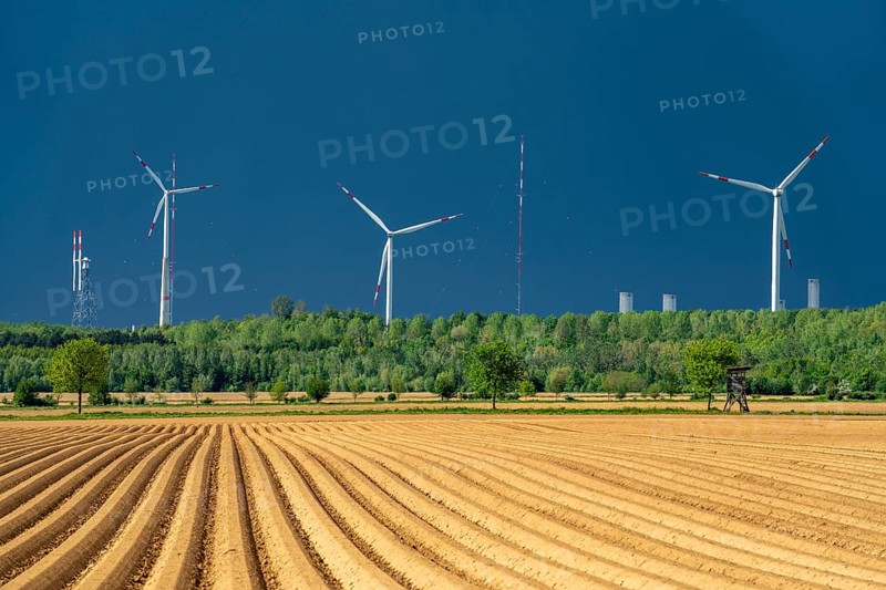 Wind turbines on the Grevenbroich wind test field, dark rain clouds, in the Rhenish lignite mining area, field with potato ridges, near Grevenbroich, North Rhine-Westphalia, Germany, Europe