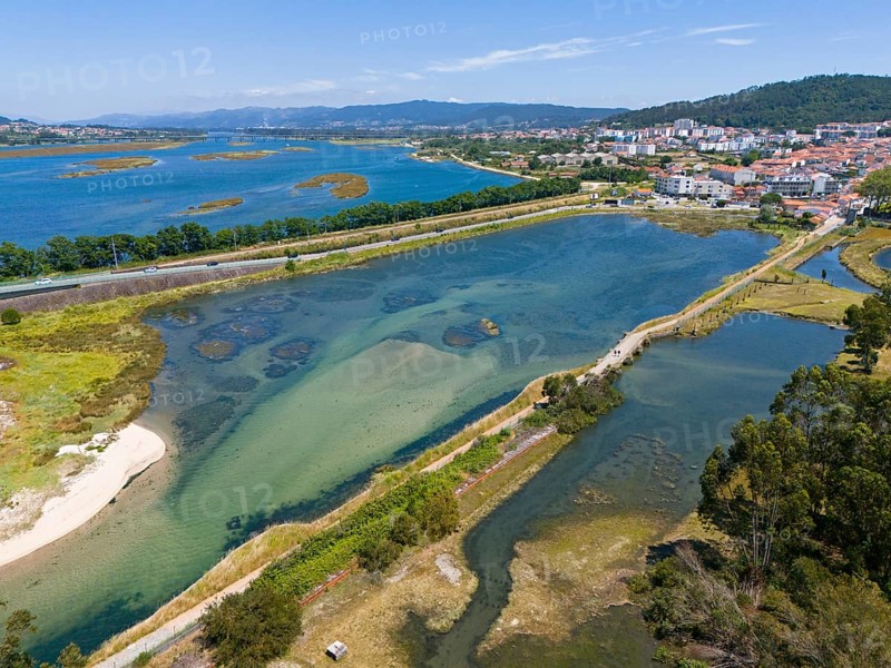 Panoramic view of a water landscape with a river course, streets and a small town surrounded by hills and nature, aerial view, Lima River, Viana do Castelo, Portugal, Europe