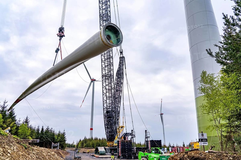 Erection of a wind turbine, wind energy plant, assembly of the third blade, with a crawler lattice crane, wind farm near Hagen, North Rhine-Westphalia, Germany, Europe