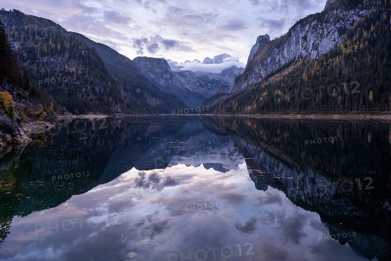 The Vordere Gosausee lake in the morning in autumn with a view of the Dachstein mountain range. The Gosaukamm on the right. Cloudy sky. Reflection. Vorderer Gosausee, Gosau, Gosau valley, Salzkammergut, Upper Austria, Austria, Europe