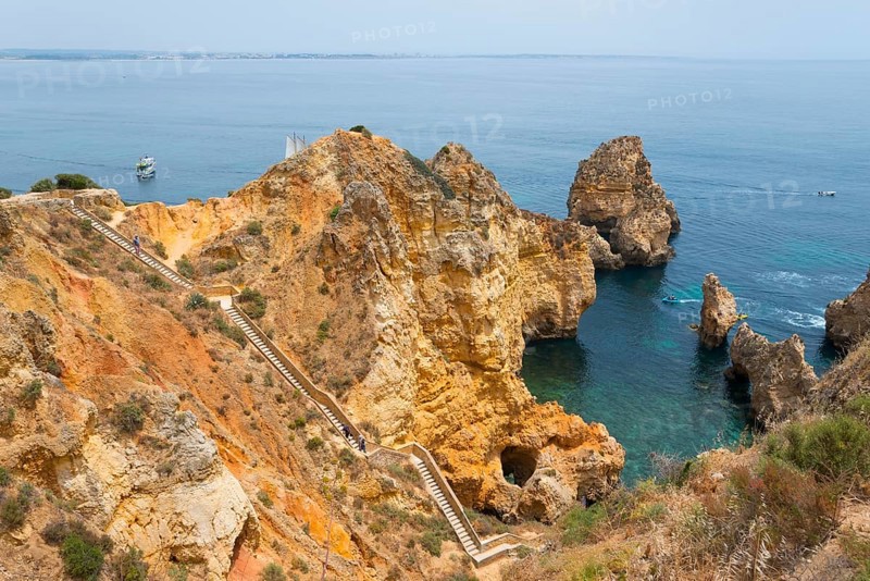 Rocks and a footpath with steps overlooking the picturesque coastline and the vast sea, Ponta da Piedade, point of mercy, Lagos, Algarve, Portugal, Europe