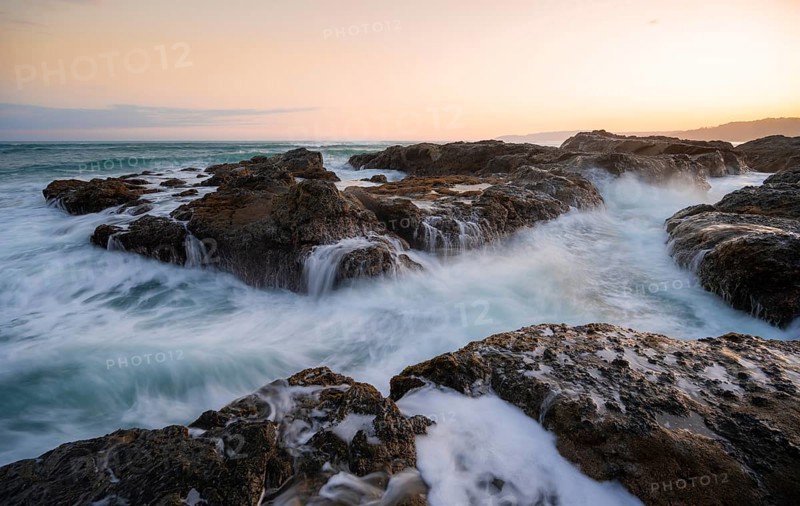 Waves washing over rocks by the sea, long exposure, coastal landscape at sunset, Playa Cocalito, Pacific coast, Nicoya Peninsula, Puntarenas province, Costa Rica, Central America
