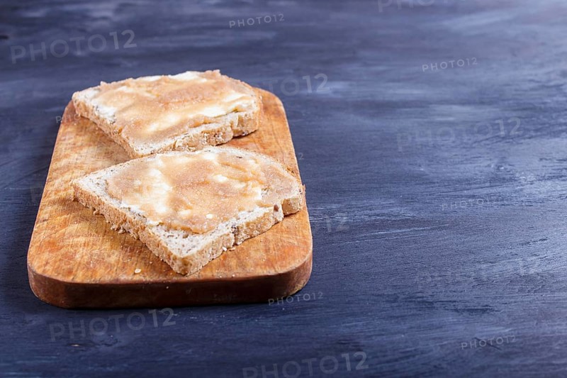 Sandwiches with pollock roe on a wooden kitchen board against black background. with copy space