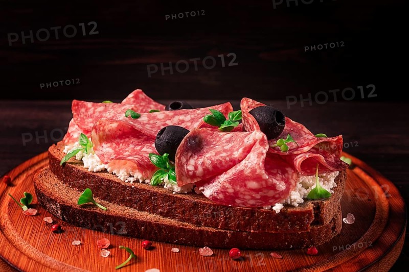 Sandwich, grain bread, with cream cheese and salami, black olives, micro-greens, top view, close-up, no people, Breakfast