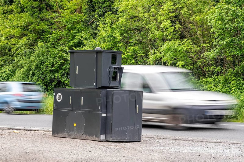 Semi-stationary speed camera on the B227, Hattinger Straße, used by the city of Gelsenkirchen, model TraffiStar S350 from Jenoptik, the device is temporary, self-sufficient for up to a week, at various measuring points, can measure and flash in 2 directions, laser measurement technology, data is sent to the city via mobile radio, is installed on a protected trailer, popularly known as an armoured speed camera, here a 50 km/h zone, North Rhine-Westphalia, Germany, Europe