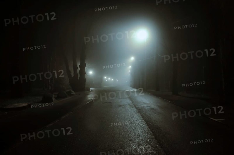 Foggy Illuminated Road at Night in Locarno, Ticino, Switzerland, Europe