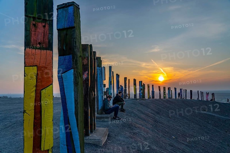 The Haniel spoil tip, 185 metre high spoil tip, at the Prosper Haniel mine, which was closed in 2019, artwork Totems by the sculptor Augustin Ibarrola, sunset, Bottrop, Germany, Europe