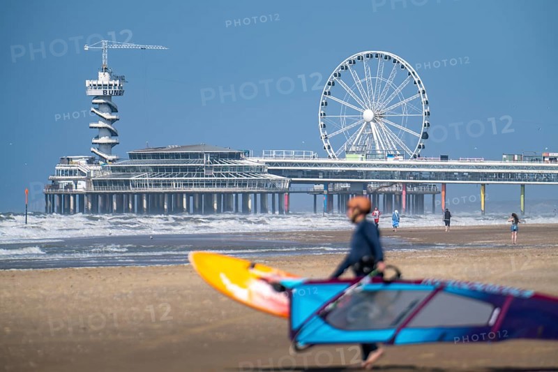 The pier and Ferris wheel at Scheveningen beach, strong swell, windsurfers, Netherlands