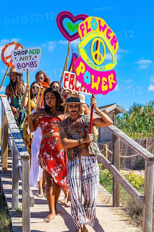 Colourfully dressed youths with musical instruments and banners form a love parade and promote the nightclub Pacha, Cala Comte, Ibiza, Balearic Islands, Mediterranean Sea, Spain, Europe