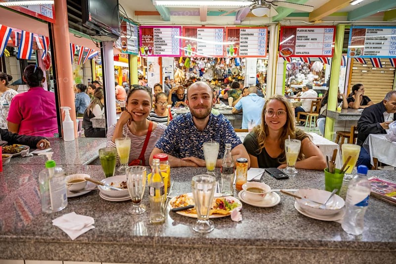Tourists sitting at a table at a food stall, Mercado Central de San José, San José, Costa Rica, Central America