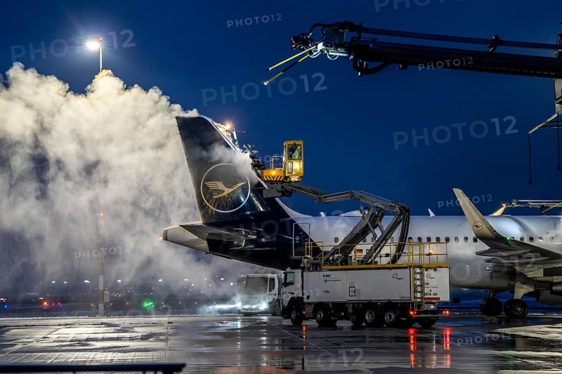 Winter at Frankfurt Main Airport, FRA, Lufthansa aircraft being de-iced by de-icing vehicles, Hesse, Germany, Europe