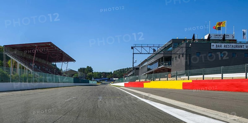 View from the perspective of a racing driver on the long start-finish straight of the Spa race track, left grandstand, right building with pit lane and pit box, FIA Formula 1 race track, Circuit de Spa Francorchamps, Ardennes rollercoaster, Ardennes, Malmedy, Belgium, Europe