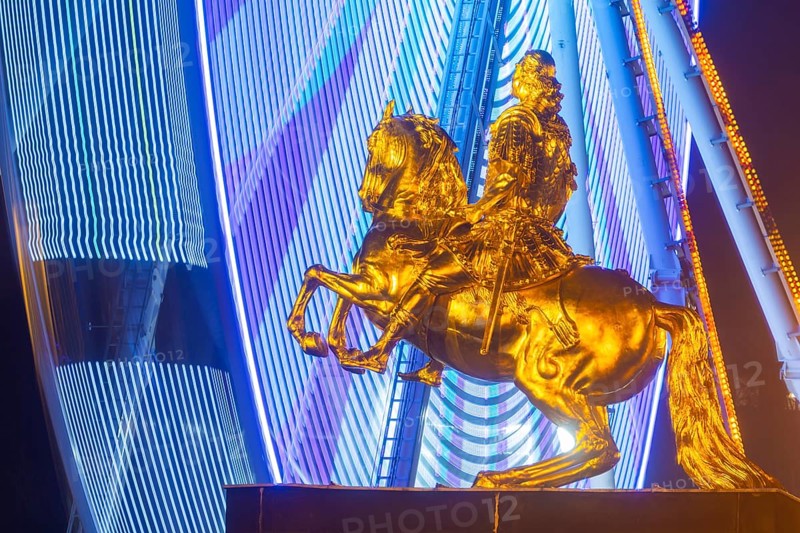 Augustus Market in Dresden. Equestrian statue of Augustus the Strong, also known as the Golden Horseman, with a Ferris wheel turning behind it, Dresden, Saxony, Germany, Europe