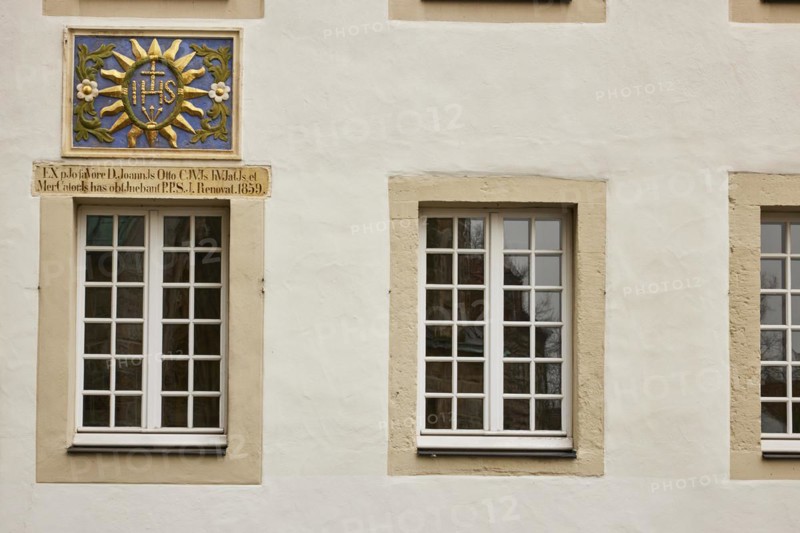 White windows a colourful family coat of arms on a house in Warendorf, Warendorf district, North Rhine-Westphalia, Germany, Europe