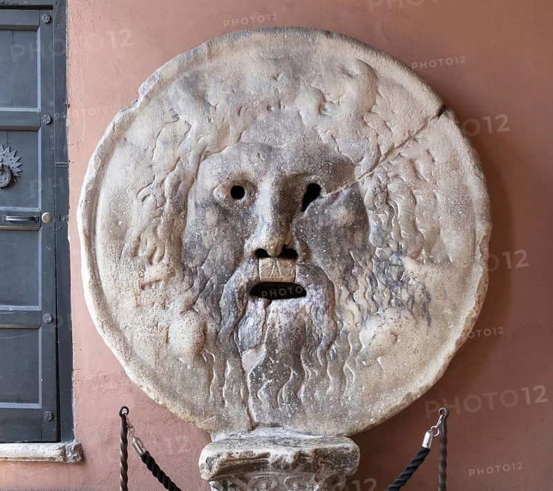 The Bocca della Verita, Mouth of Truth is a disc-shaped relief, in the portico of the Santa Maria in Cosmedin church, Rome, Italy / Mouth of Truth, Bocca della Verita, a marble mask in the portico of the Santa Maria in Cosmedin church, Rome, Italy, Europe