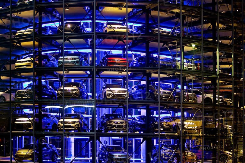 An illuminated car tower with new cars for delivery in the evening, detail, Autostadt, Volkswagen AG, Wolfsburg, Lower Saxony, Germany, Europe