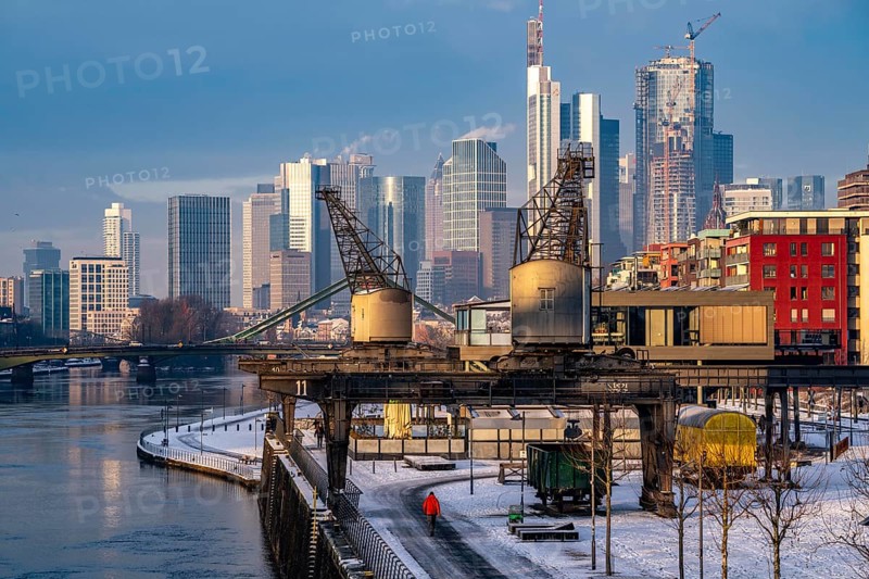 The skyline of Frankfurt am Main, skyscrapers of the banking district, historic harbour cranes at the Wesel shipyard, wintry morning, Hesse, Germany, Europe