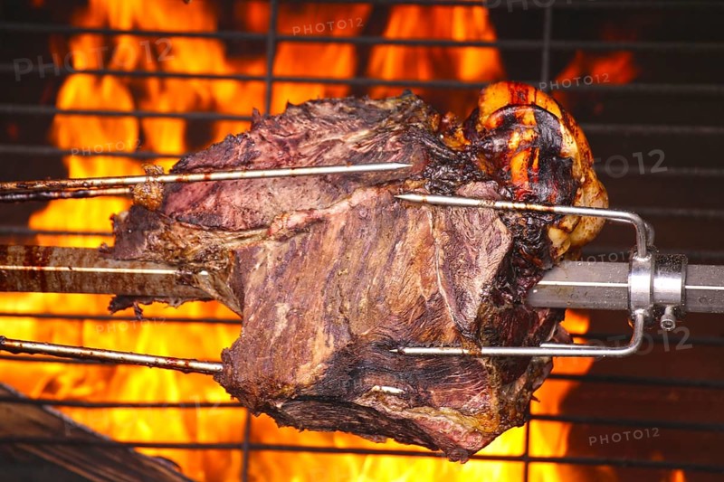 Suckling pig leg on the spit