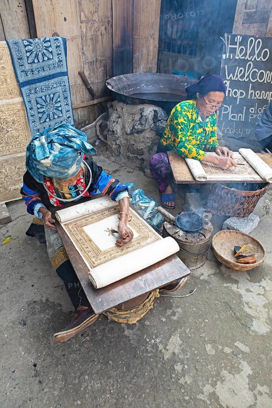 Vietnamese woman from the Hmong minority draw patterns on linen fabric, Lung Tam linen weaving mill, Ha Giang province, Vietnam, Asia