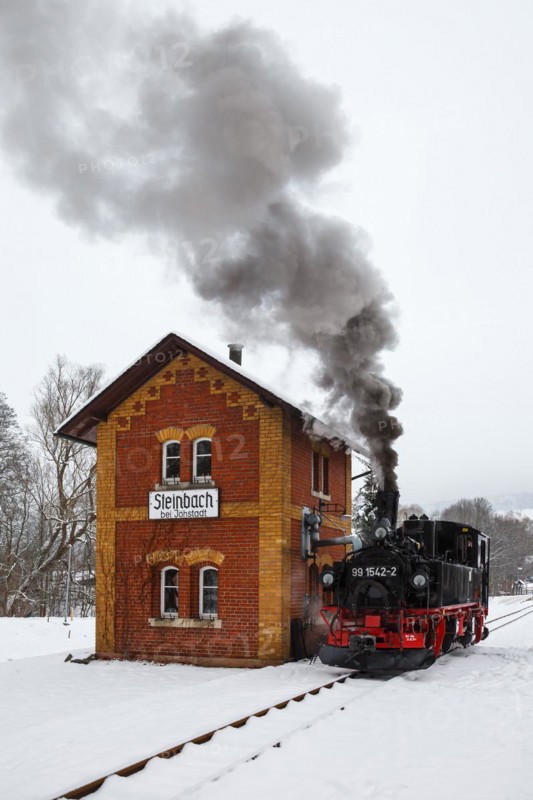Steam train of the Preßnitztalbahn railway Steam locomotive in winter in Steinbach, Germany, Europe