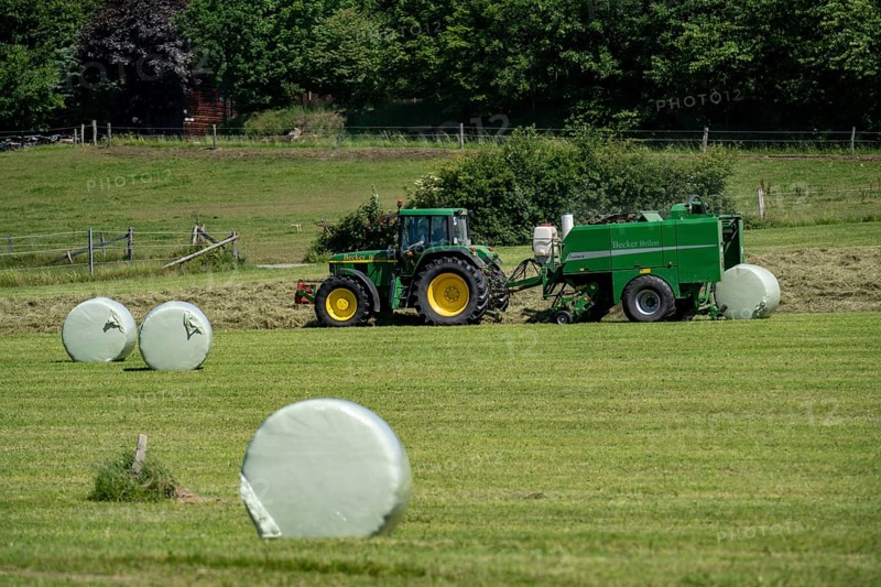 Hay harvest, farmer with agricultural machine, picks up mown hay, which is immediately pressed into bales and wrapped in film, baler/wrapper combination, Sauerland, Hochsauerlandkreis, near Siedlinghausen, North Rhine-Westphalia, Germany, Europe